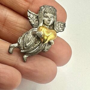 D.M. 95 silver tone angel holding gold tone  heart